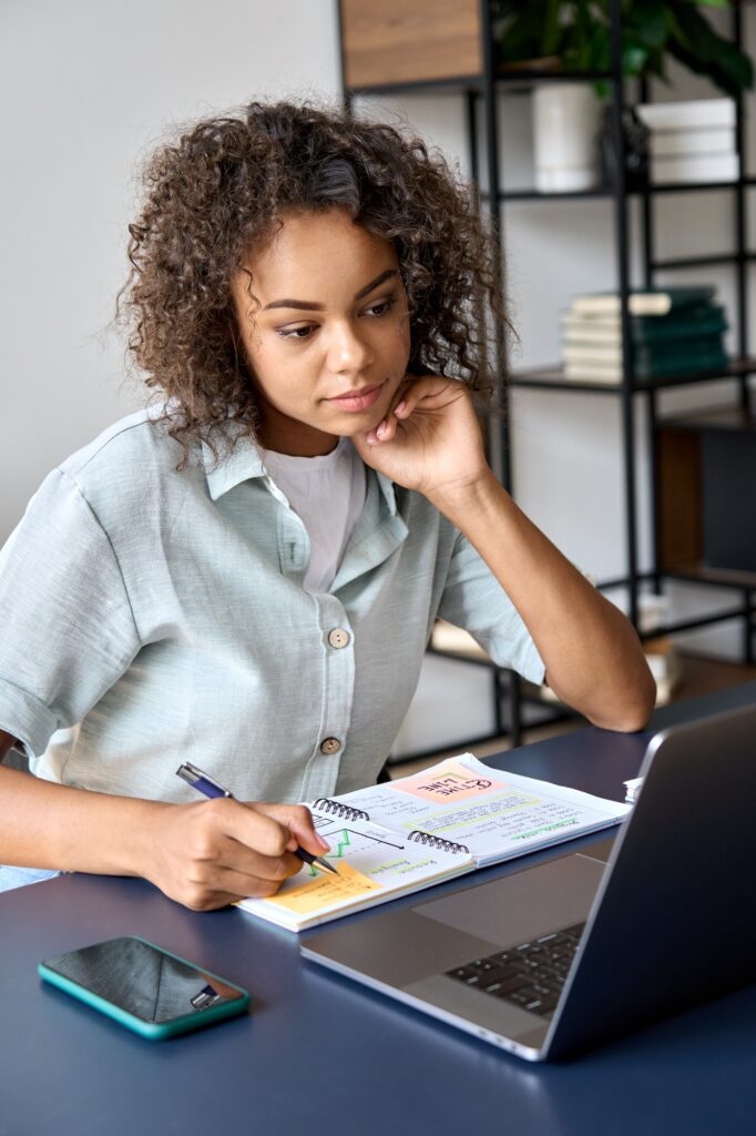 African American student girl having video call videoconference on laptop.